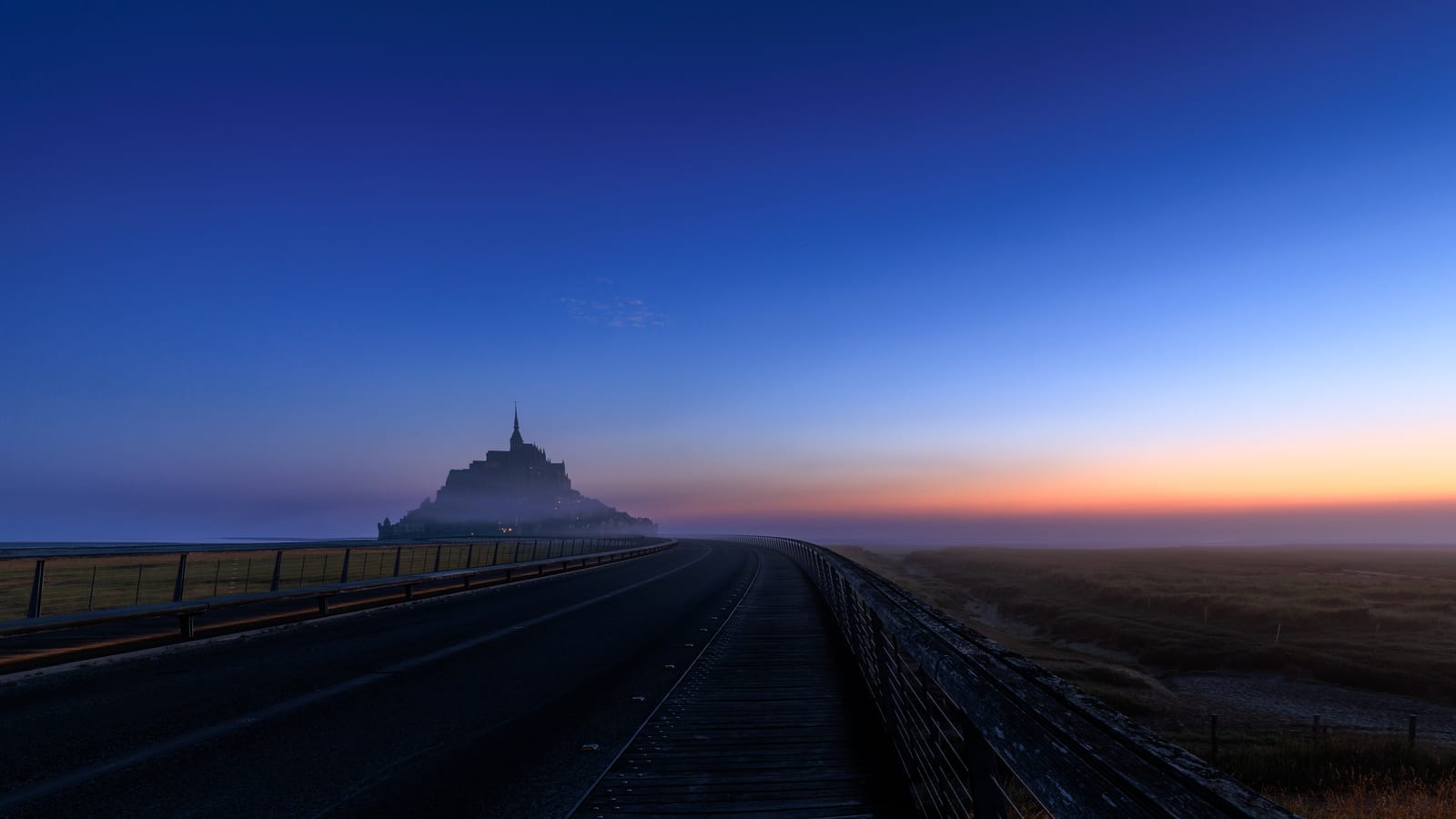 Mont Saint Michel in the mist at sunrise
